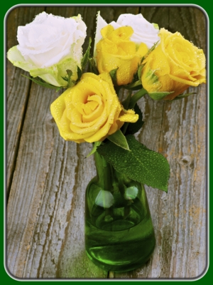 Yellow and White Roses in Green Glass Vase