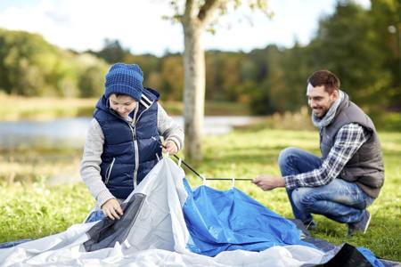 Father and son building tent