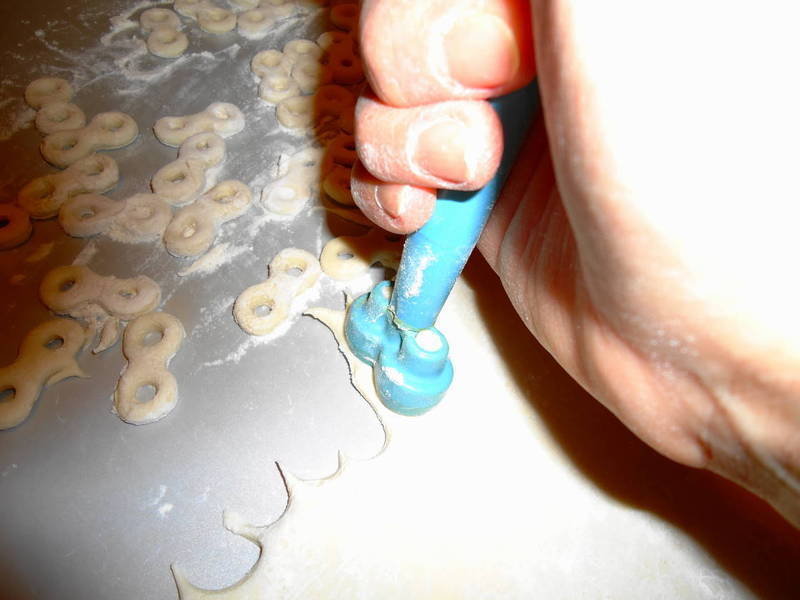 Cutting out dough eights with the special instrument for mucenici