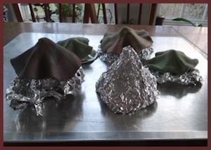 Clay caps and foil forms on baking sheet