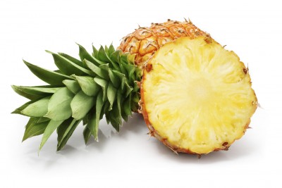 fresh pineapple fruits with cut and green leaves