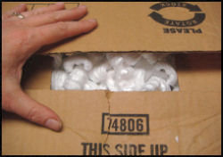 closing box, shows box is slightly overfilled with packing peanuts
