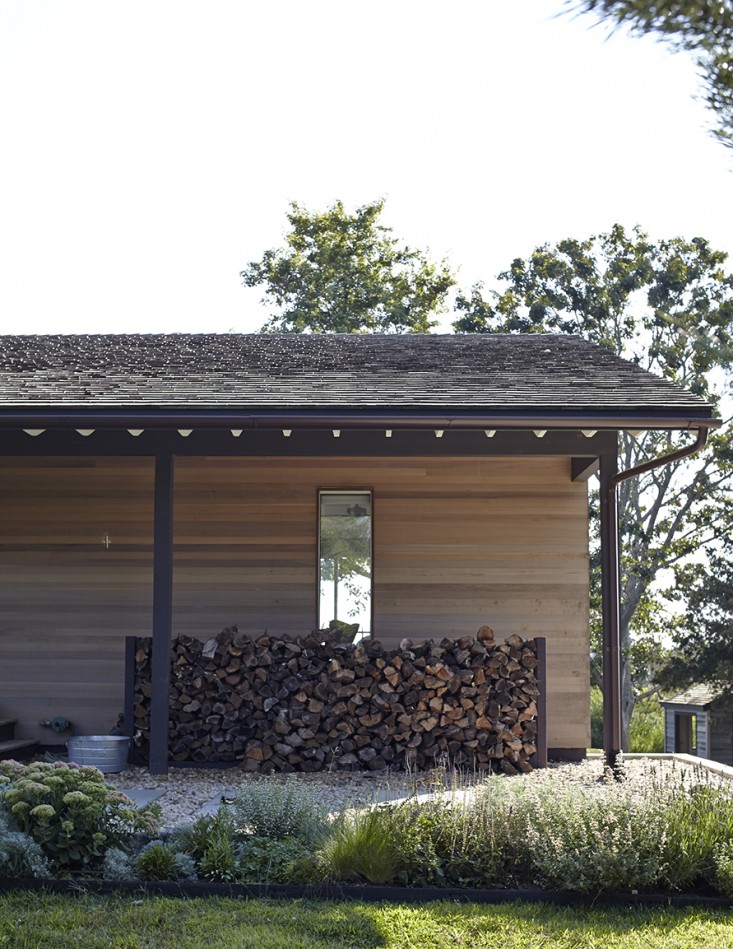 Shelter_Island_Ochre_Canvas_Home_garden__wood_pile_woodpile_gardenista_facade_1